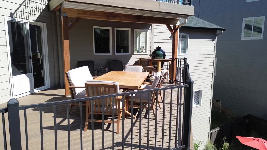 Covered deck and outdoor living space by Winding River Construction